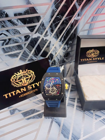Luxury watch with blue strap and colorful face on a marble surface with Titan Style branding.